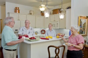 Friends hanging out in kitchen eating breakfast together