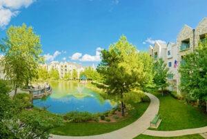 Panorama of pond and fountain outside of buildings