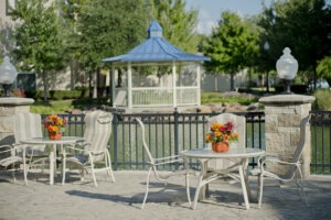 Outside tables and chairs next to pond