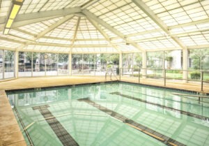 Indoor pool with glass doors on all sides