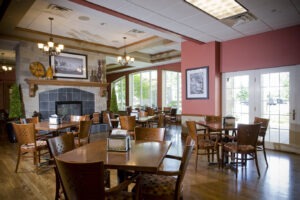 Bistro with tables and chairs and a fireplace in the background