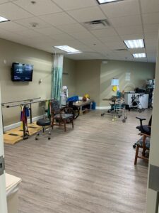 Rehabilitation area with assortment of walkers and physical therapy items