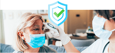 woman in a medical mask getting her temperature taken